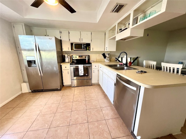 kitchen featuring ceiling fan, sink, stainless steel appliances, light tile patterned floors, and white cabinets