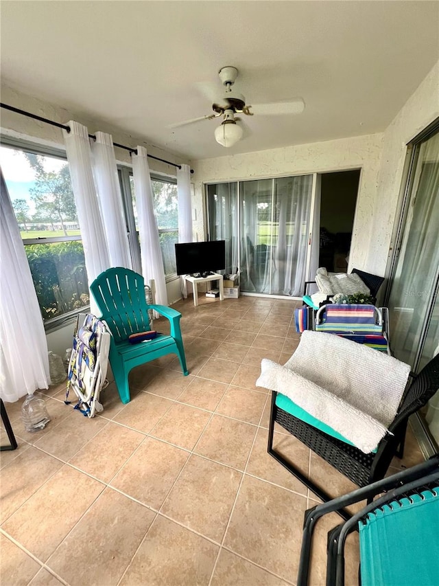 sunroom featuring ceiling fan