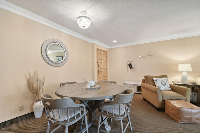 dining space featuring dark carpet, ornamental molding, a textured ceiling, and a chandelier