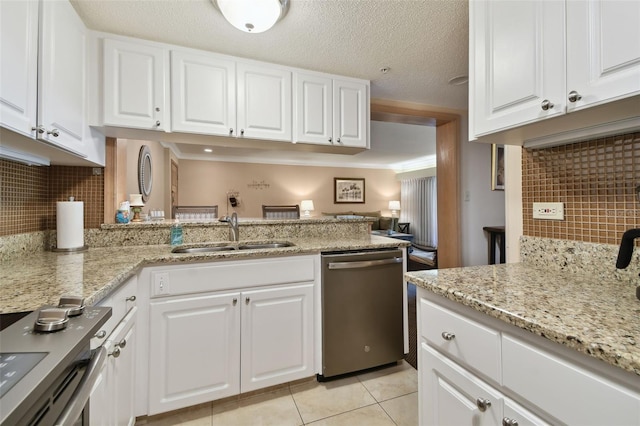 kitchen featuring stainless steel dishwasher, white cabinets, and backsplash