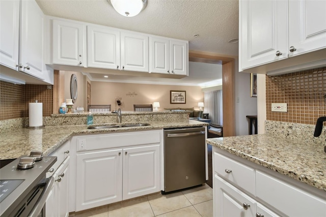 36750 US Highway 19 N Unit 19219, Palm Harbor, FL 34684 - kitchen featuring appliances with stainless steel finishes, a sink, tasteful backsplash, light tile patterned flooring, and white cabinets
