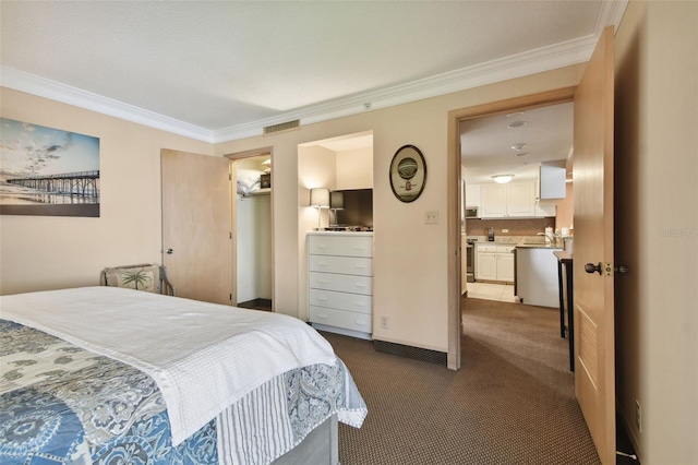 carpeted bedroom featuring connected bathroom, a closet, and crown molding