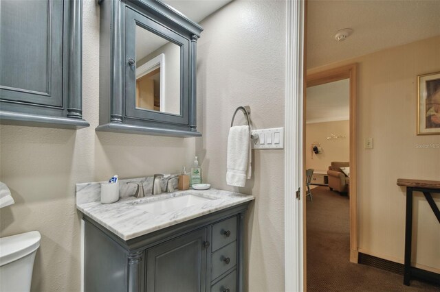 36750 US Highway 19 N Unit 19219, Palm Harbor, FL 34684 - bathroom featuring toilet, vanity, and a textured wall