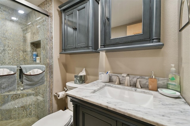 bathroom featuring vanity, toilet, and an enclosed shower