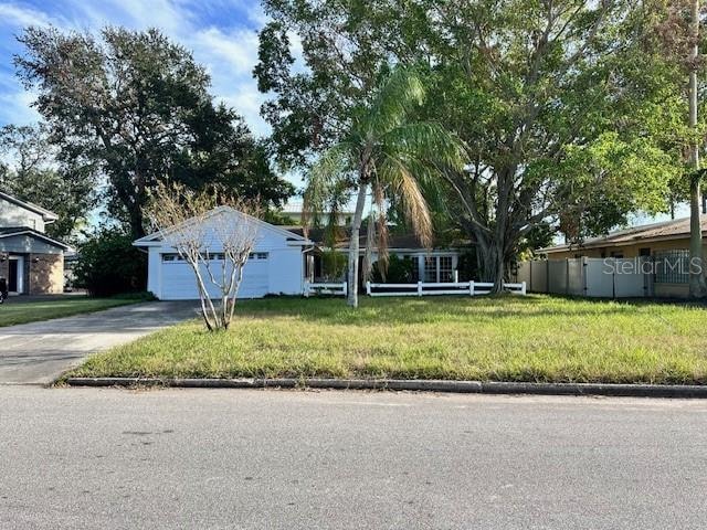 view of front of house featuring a garage and a front lawn