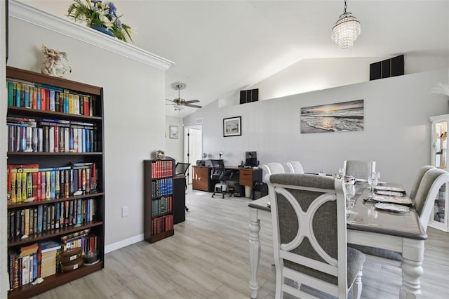 dining space with ceiling fan, baseboards, lofted ceiling, and wood finished floors