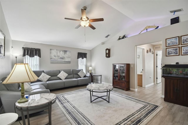 living room with vaulted ceiling, light wood-style floors, visible vents, and ceiling fan