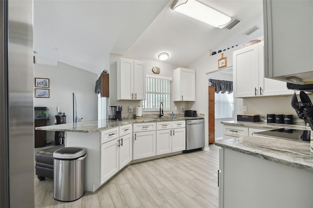 kitchen with visible vents, dishwasher, lofted ceiling, a peninsula, and white cabinetry