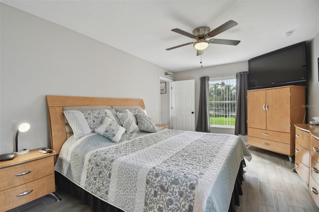 bedroom with a ceiling fan and wood finished floors