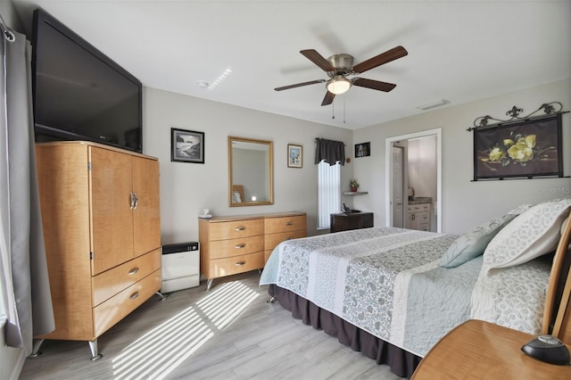 bedroom featuring light wood-type flooring, visible vents, and ceiling fan