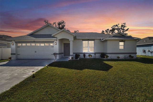 ranch-style house with a front yard, driveway, a shingled roof, stucco siding, and a garage