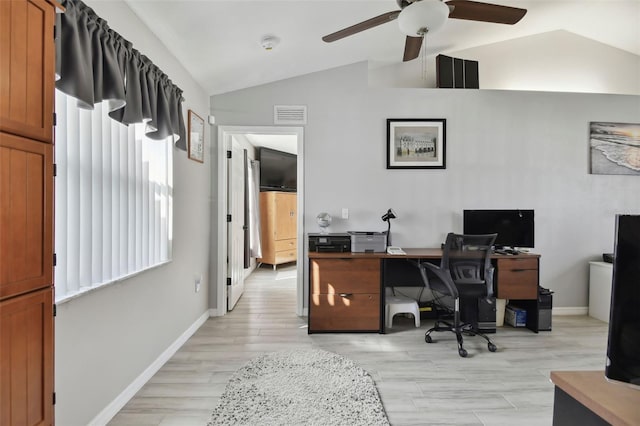 home office with visible vents, light wood-style flooring, baseboards, and lofted ceiling