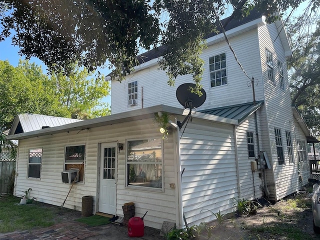 back of house featuring cooling unit