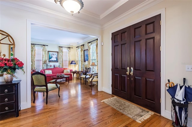 entryway featuring crown molding, plenty of natural light, and light hardwood / wood-style flooring