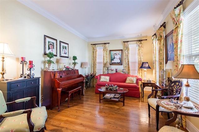 living area featuring crown molding and light wood-type flooring