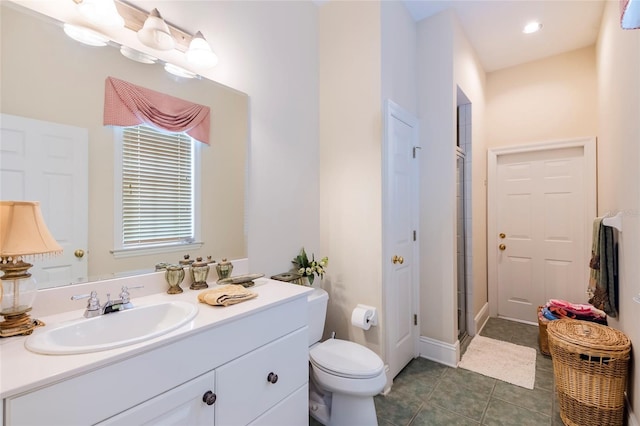 bathroom with tile patterned flooring, vanity, an enclosed shower, and toilet