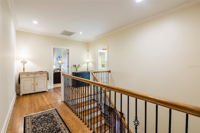 corridor featuring crown molding and light hardwood / wood-style floors