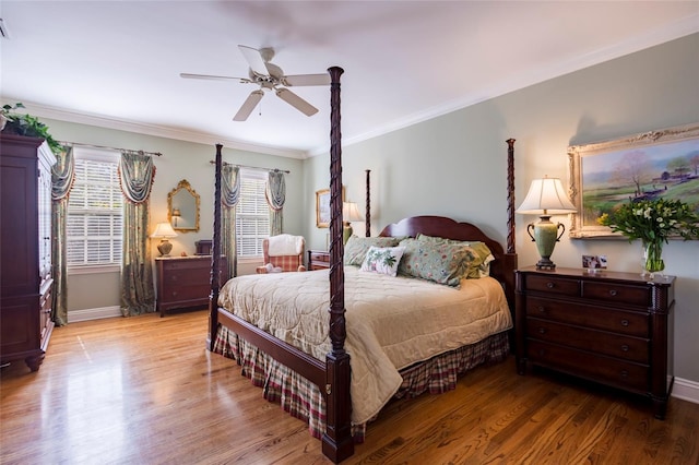 bedroom featuring light hardwood / wood-style floors, ceiling fan, and crown molding