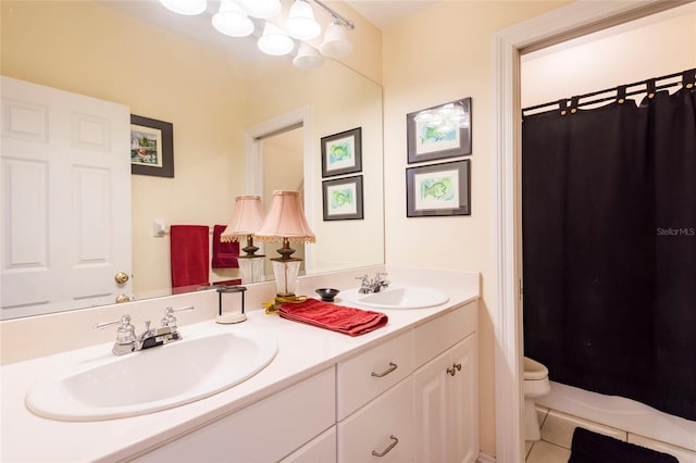 bathroom with tile patterned flooring, vanity, toilet, and a shower with curtain