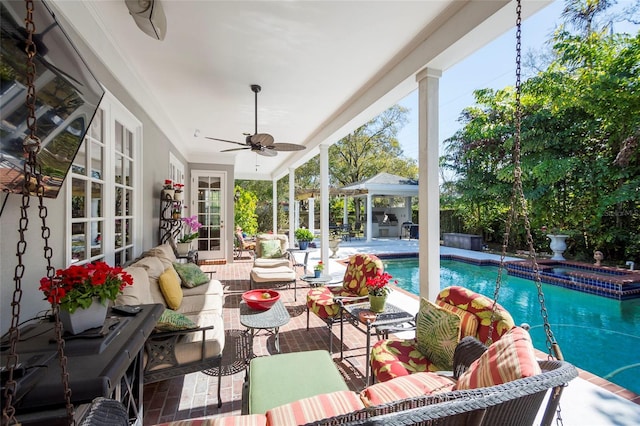 sunroom / solarium featuring ceiling fan