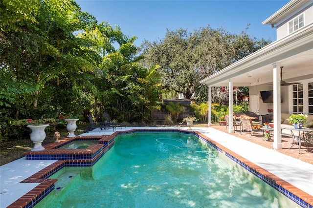 view of pool with a patio area, an in ground hot tub, and ceiling fan