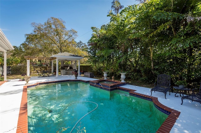 view of pool with an in ground hot tub and a patio area