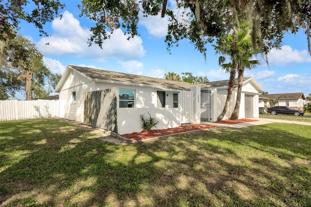 view of front of house with a garage and a front lawn