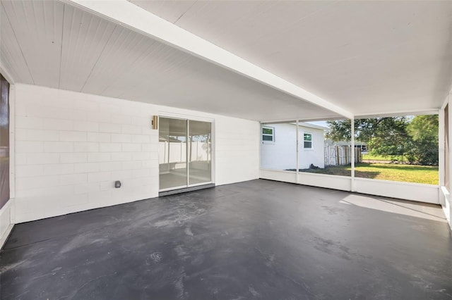 unfurnished sunroom with beamed ceiling and plenty of natural light