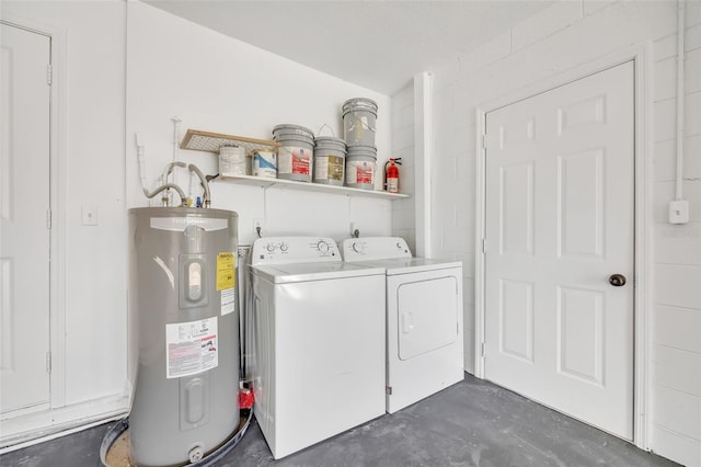 laundry room featuring washer and clothes dryer and water heater