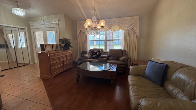 living room with light tile patterned floors, french doors, and an inviting chandelier