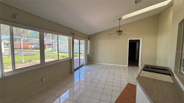 interior space with ceiling fan, light tile patterned floors, and high vaulted ceiling