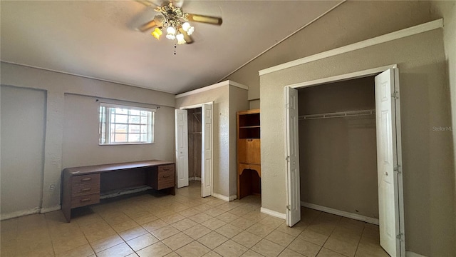 unfurnished bedroom with light tile patterned floors, vaulted ceiling, and ceiling fan