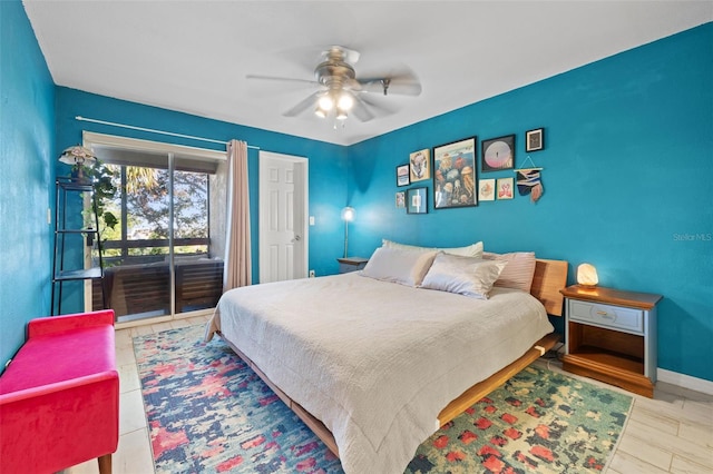 bedroom with ceiling fan, wood-type flooring, and access to outside