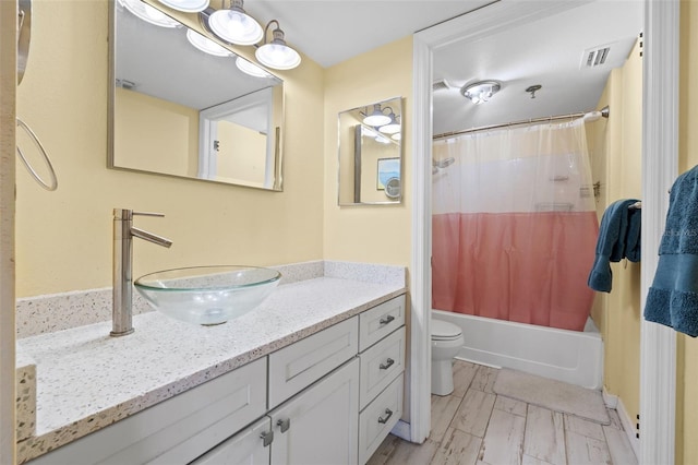 full bathroom featuring vanity, toilet, and shower / tub combo with curtain