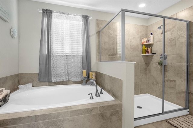 bathroom featuring separate shower and tub