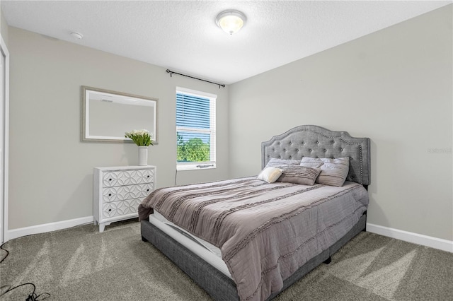 bedroom featuring carpet floors and a textured ceiling