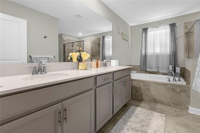 bathroom featuring tile patterned floors, vanity, and plus walk in shower