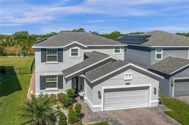 view of property with a front lawn and a garage