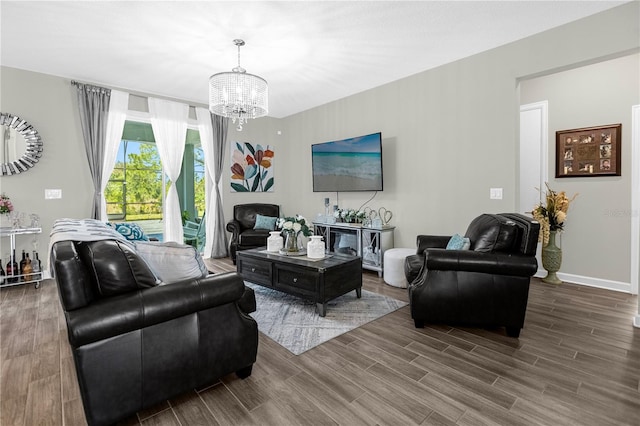 living room with hardwood / wood-style flooring and a notable chandelier