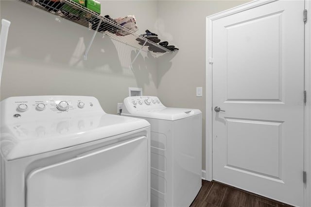 laundry area featuring washer and dryer and dark wood-type flooring