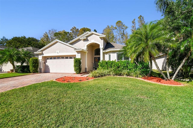 view of front of home with a front lawn and a garage