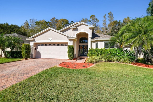 view of front of house with a garage and a front yard