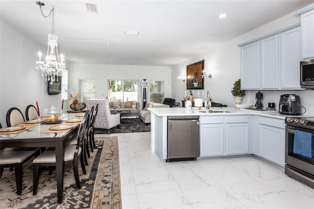 kitchen with pendant lighting, sink, and stainless steel appliances