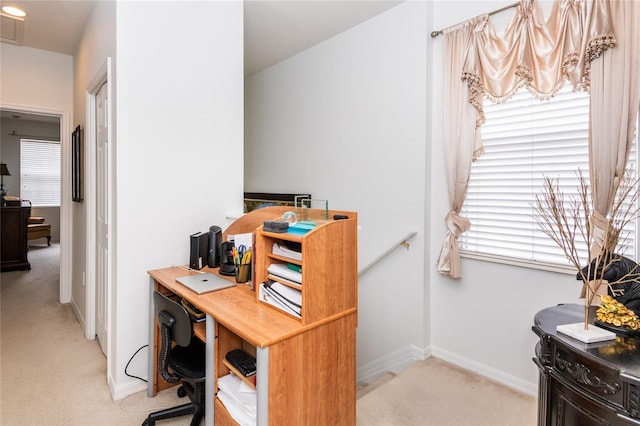 office space with plenty of natural light and light colored carpet