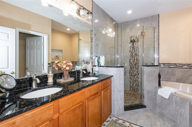 bathroom featuring tile patterned flooring, vanity, and shower with separate bathtub