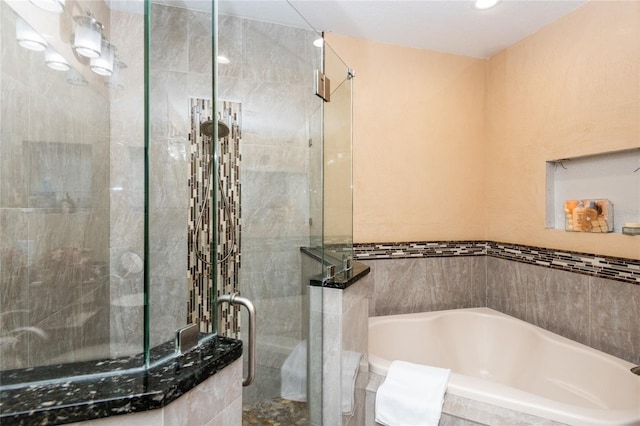 bathroom with shower with separate bathtub