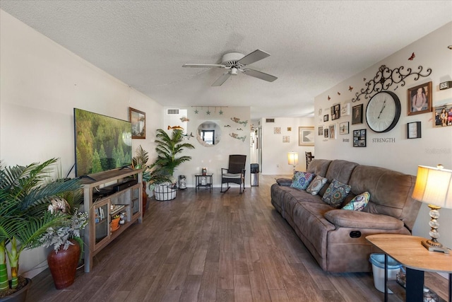 living room featuring a textured ceiling, ceiling fan, and dark hardwood / wood-style floors