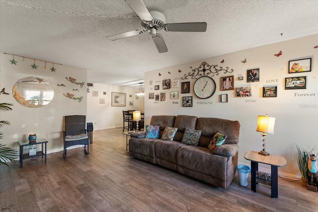 living room with dark hardwood / wood-style flooring and a textured ceiling