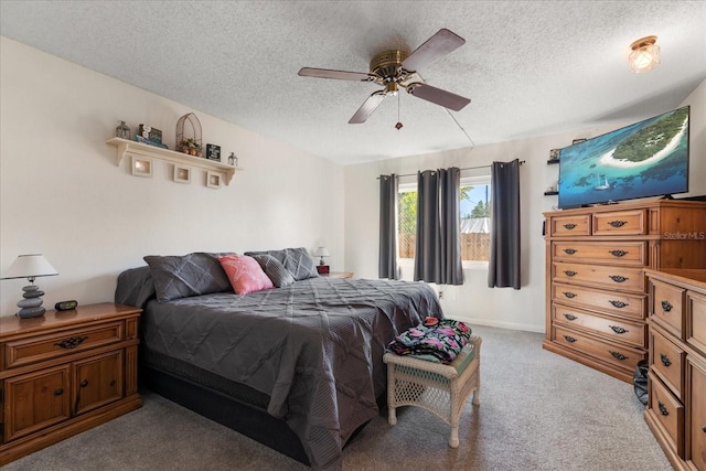 bedroom featuring ceiling fan, light colored carpet, and a textured ceiling