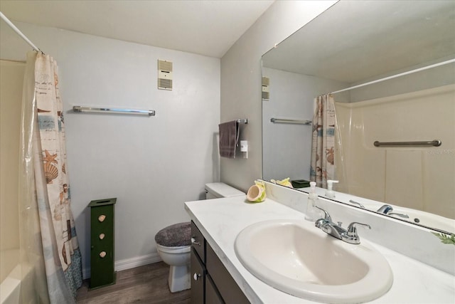 full bathroom with hardwood / wood-style floors, vanity, toilet, and shower / tub combo